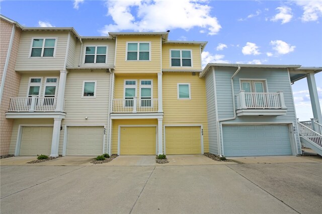 view of property with a balcony and a garage