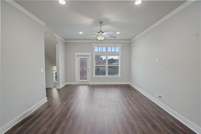 unfurnished living room featuring dark wood-type flooring, ceiling fan, and ornamental molding