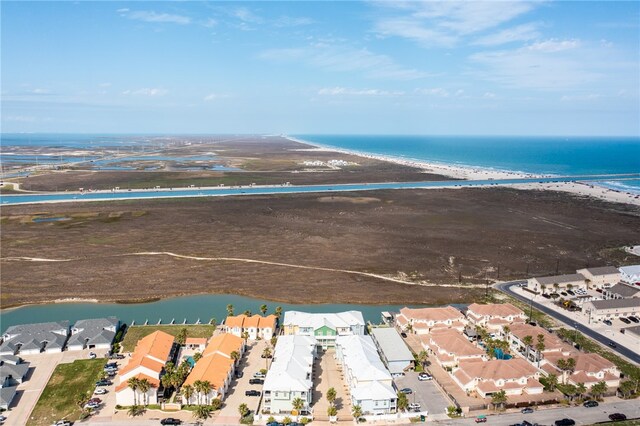 birds eye view of property with a view of the beach and a water view