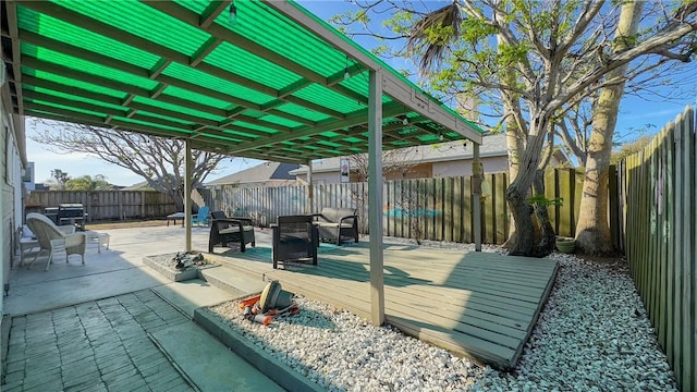 view of patio with a deck and a fenced backyard