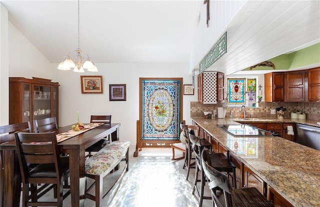 dining space with a chandelier and vaulted ceiling