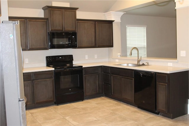 kitchen with decorative columns, black appliances, sink, kitchen peninsula, and dark brown cabinets