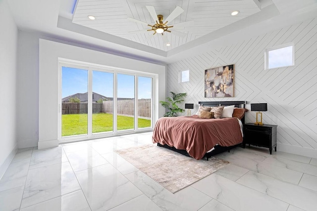 5402 Bonanza Dr, Corpus Christi, TX 78414 - bedroom featuring marble look tiles, baseboards, an accent wall, a tray ceiling, and recessed lighting