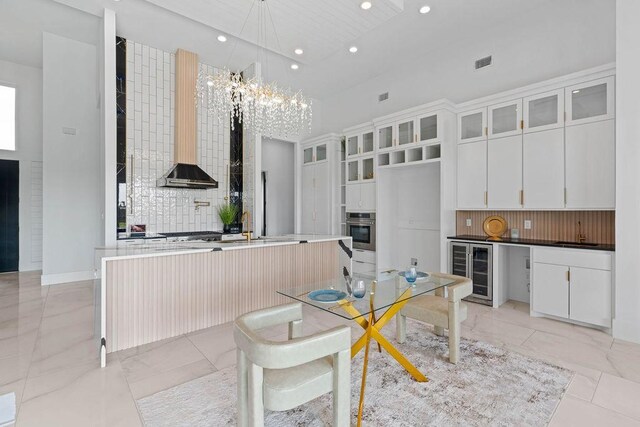 5402 Bonanza Dr, Corpus Christi, TX 78414 - kitchen with stainless steel oven, beverage cooler, tasteful backsplash, a chandelier, and recessed lighting