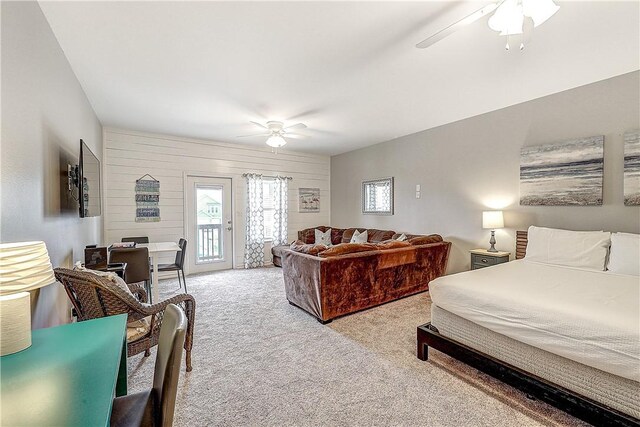 bedroom with carpet floors, access to outside, and ceiling fan