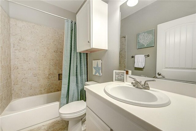 full bath featuring toilet, shower / bath combination with curtain, and vanity