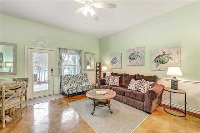 living room with ceiling fan and baseboards