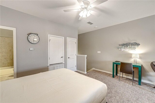 bedroom featuring a ceiling fan, visible vents, carpet floors, baseboards, and ensuite bath