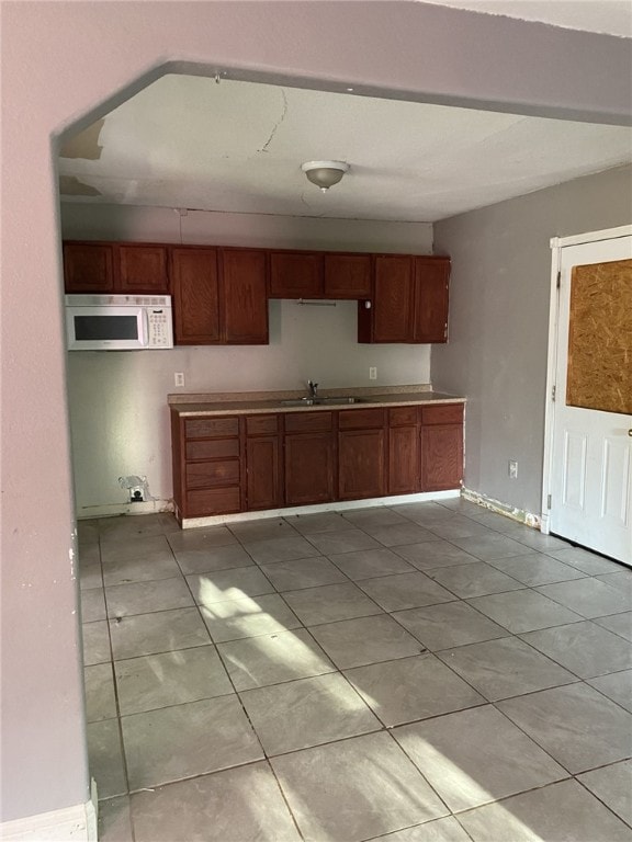 kitchen with sink and light tile patterned floors