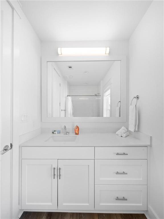 bathroom featuring curtained shower and vanity