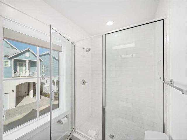 bathroom with toilet and a stall shower
