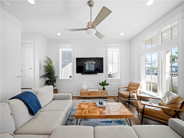 living area with ceiling fan, wood finished floors, and recessed lighting