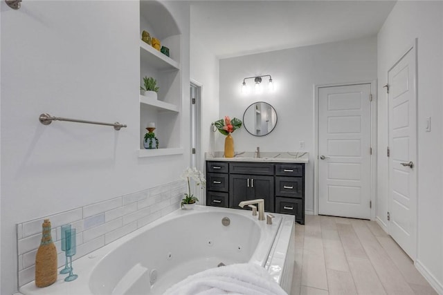 104 Emerald St, Portland, TX 78374 - full bathroom featuring a jetted tub, vanity, and wood finished floors
