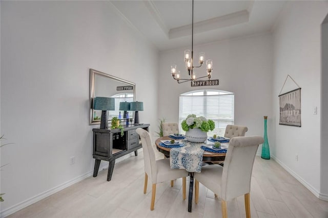 104 Emerald St, Portland, TX 78374 - dining space with a chandelier, light wood-type flooring, baseboards, ornamental molding, and a raised ceiling
