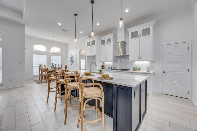 104 Emerald St, Portland, TX 78374 - kitchen with a chandelier, backsplash, white cabinetry, a center island with sink, and recessed lighting