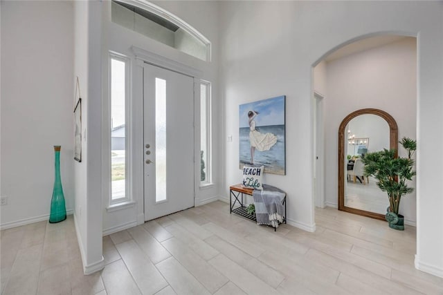 104 Emerald St, Portland, TX 78374 - foyer entrance featuring arched walkways, baseboards, and a high ceiling