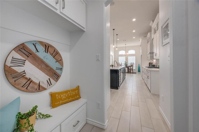 104 Emerald St, Portland, TX 78374 - corridor featuring a sink, recessed lighting, a chandelier, and baseboards