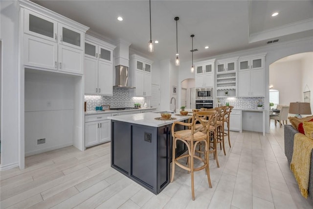 104 Emerald St, Portland, TX 78374 - kitchen with arched walkways, stainless steel microwave, decorative backsplash, a sink, and recessed lighting