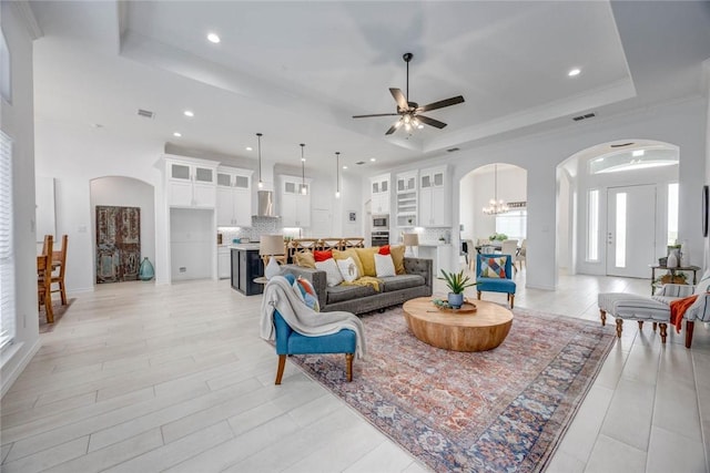 104 Emerald St, Portland, TX 78374 - living area with a tray ceiling, arched walkways, ceiling fan, plenty of natural light, and recessed lighting