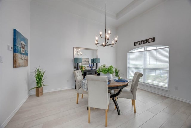 104 Emerald St, Portland, TX 78374 - dining space featuring a chandelier, a high ceiling, ornamental molding, and baseboards