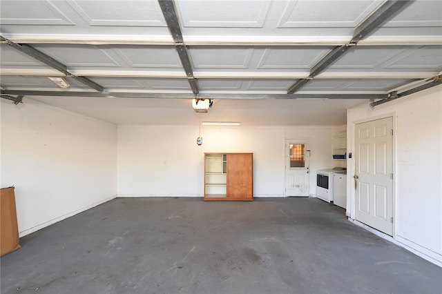 garage with a garage door opener and washing machine and clothes dryer