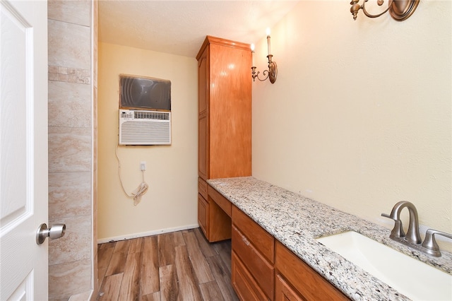 bathroom featuring vanity, hardwood / wood-style flooring, and a textured ceiling