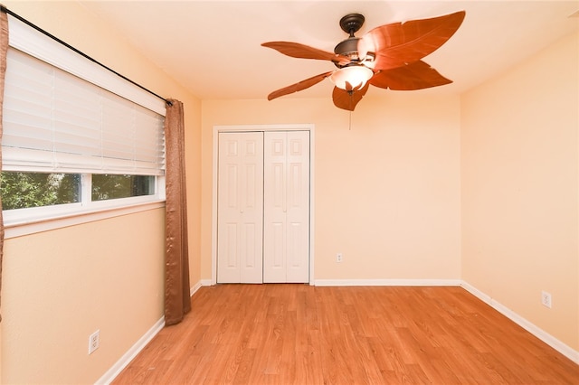 unfurnished bedroom with ceiling fan, a closet, and light hardwood / wood-style flooring