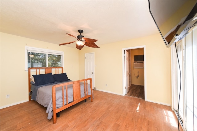 bedroom featuring ensuite bath, a textured ceiling, ceiling fan, a closet, and light wood-type flooring