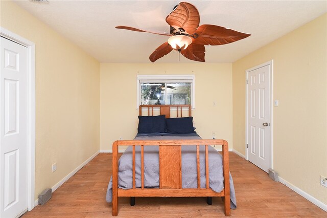 bedroom with hardwood / wood-style floors and ceiling fan