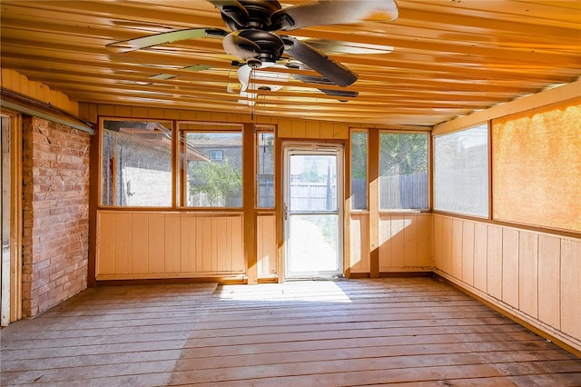 unfurnished sunroom featuring wood ceiling and ceiling fan