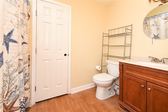 bathroom featuring hardwood / wood-style flooring, vanity, and toilet