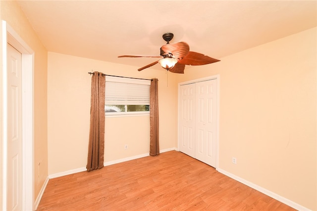 unfurnished bedroom with a closet, light hardwood / wood-style floors, and ceiling fan