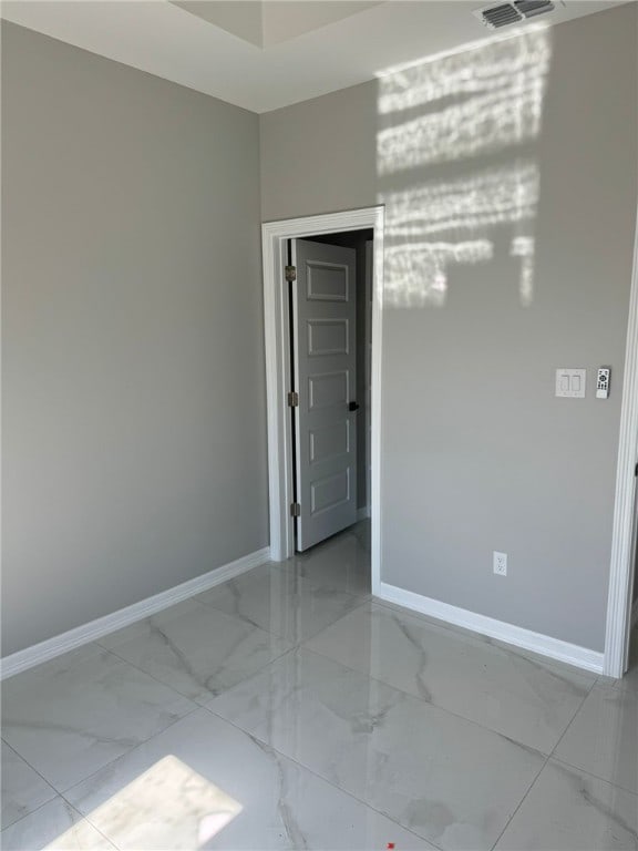 unfurnished room with an inviting chandelier