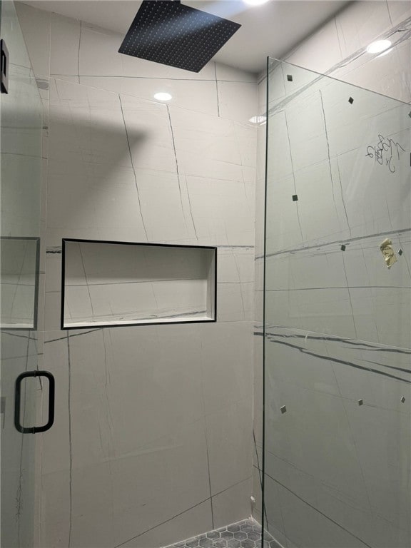 bathroom with a shower with shower door