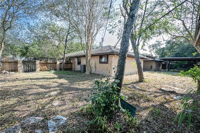 743 Retama Ave, Taft, TX 78390 - view of yard with central AC unit, fence, and a gate