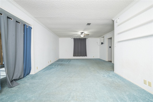 interior space with a textured ceiling, carpet, ceiling fan, and crown molding