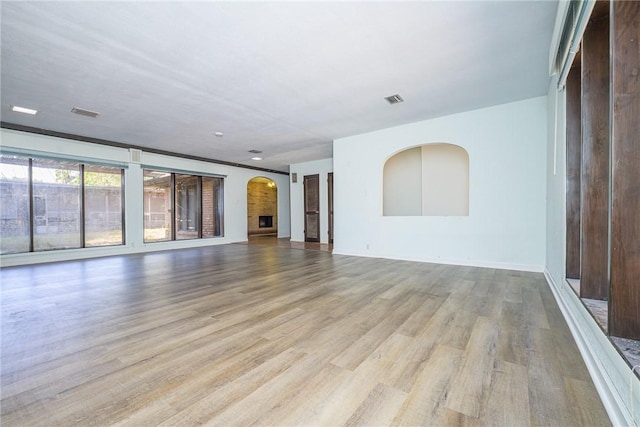 743 Retama Ave, Taft, TX 78390 - unfurnished living room featuring wood finished floors and arched walkways