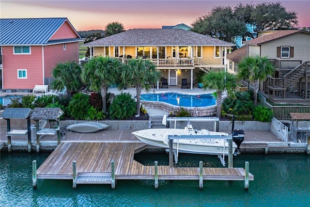 back house at dusk with a water view