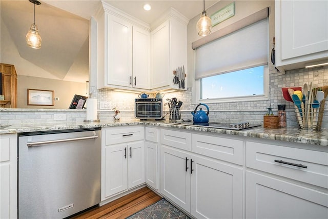 kitchen featuring decorative light fixtures, white cabinets, black electric stovetop, stainless steel dishwasher, and light stone counters