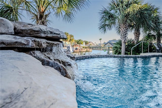 view of pool featuring a water view