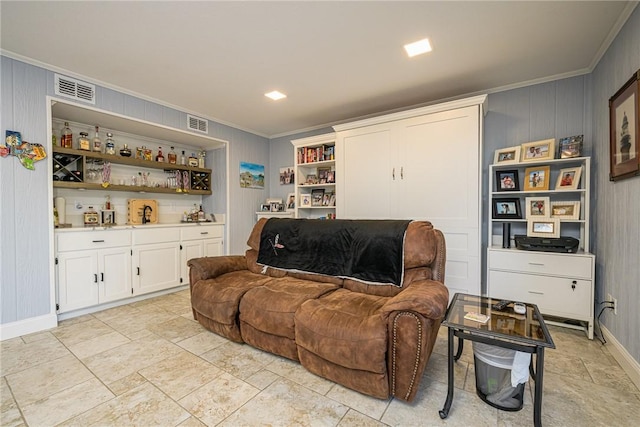 living room with indoor bar and ornamental molding