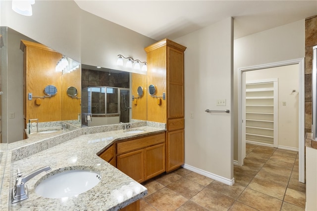 bathroom featuring walk in shower, tile patterned flooring, and vanity