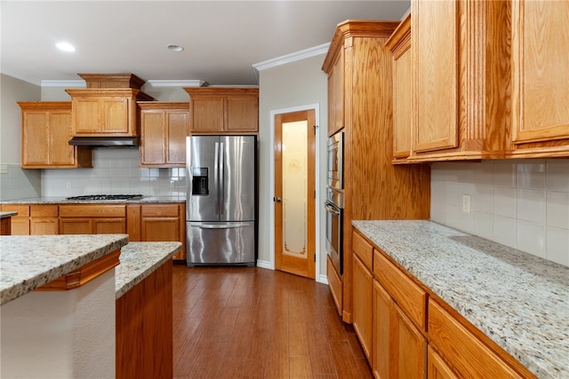 kitchen with dark wood-type flooring, decorative backsplash, crown molding, light stone countertops, and appliances with stainless steel finishes