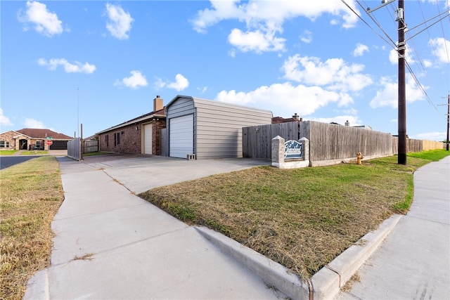 view of side of home with a garage and a lawn