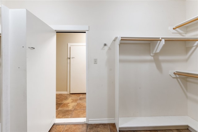 spacious closet featuring light tile patterned floors