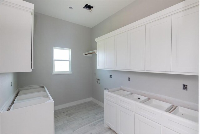 4033 Ranch Lake Dr, Corpus Christi, TX 78413 - laundry room featuring cabinet space, light wood-style floors, washer hookup, and hookup for an electric dryer