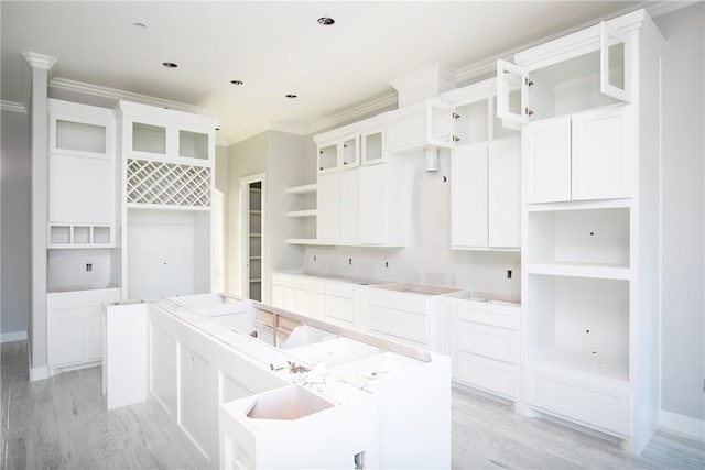 4033 Ranch Lake Dr, Corpus Christi, TX 78413 - kitchen featuring open shelves, light wood-style flooring, a center island, crown molding, and glass insert cabinets