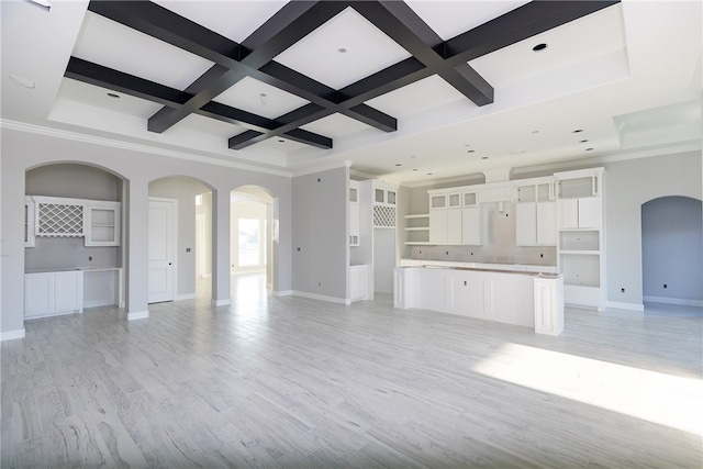 unfurnished living room featuring light hardwood / wood-style flooring, beamed ceiling, crown molding, and coffered ceiling