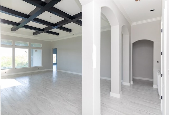 empty room featuring light wood-type flooring, beamed ceiling, crown molding, and coffered ceiling