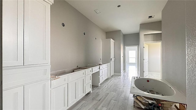 4033 Ranch Lake Dr, Corpus Christi, TX 78413 - bathroom with a jetted tub, wood finished floors, and double vanity